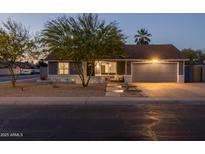 Charming single-story home with a well-maintained yard and two-car garage, perfect for suburban living at 300 E Moore Ave, Gilbert, AZ 85234