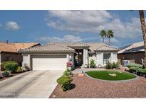 Charming single-story home with a well-manicured front yard and a two-car garage in a sunny locale at 3070 N 148Th Dr, Goodyear, AZ 85395