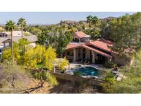 Aerial view of a home with a backyard pool, desert landscaping, and mountain views at 3522 E Cherokee St, Phoenix, AZ 85044