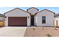 Charming single-story home with a stucco exterior, brown trim, a two car garage, and a low-maintenance landscaped yard at 537 E Aurora Dr, San Tan Valley, AZ 85140