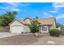 Charming single-story home featuring a well-manicured front yard and a two-car garage at 616 E Sheffield Ave, Gilbert, AZ 85296