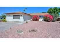 Charming single-story home featuring vibrant pink bougainvillea and a low-maintenance desert landscape at 635 W Gable Ave, Mesa, AZ 85210
