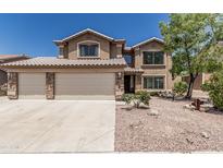 Charming two-story home featuring a three-car garage, desert landscaping, and a neutral color palette at 6422 W Range Mule Dr, Phoenix, AZ 85083