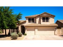 Charming two-story home with a well-manicured lawn and a two car garage at 9052 E Hobart St, Mesa, AZ 85207