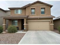 Two-story home featuring a two-car garage, covered porch, and a well-maintained front yard at 11644 W Redfield Rd, El Mirage, AZ 85335