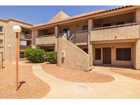 Charming condo complex featuring a terracotta tile roof and desert landscaping at 11666 N 28Th Dr # 295, Phoenix, AZ 85029
