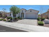 Charming single-story home with a well-manicured front yard and a brick-paved driveway at 11807 W Parkway Ln, Avondale, AZ 85323