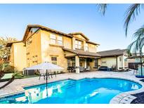 Inviting backyard pool with umbrella and outdoor seating perfect for entertaining guests at 13686 N 151St Dr, Surprise, AZ 85379