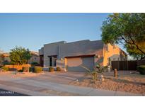 Contemporary home exterior with desert landscaping, a two-car garage, and stucco finish at 14045 E Geronimo Rd, Scottsdale, AZ 85259