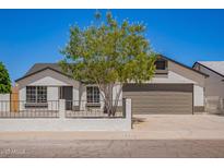Charming single-Gathering home featuring well-maintained landscaping, a spacious driveway, and a welcoming two-car garage at 1408 E Carson Rd, Phoenix, AZ 85042