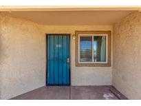 Welcoming entryway featuring a secure teal door and window, creating a bright, inviting entrance at 2220 W Dora St # 220, Mesa, AZ 85201