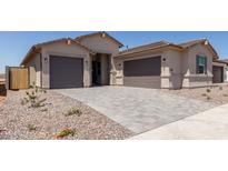 Charming new home showcasing a three-car garage and beautiful desert landscaping at 25324 N 131St Dr, Peoria, AZ 85383