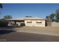 Charming single-story home featuring a classic desert landscape with an attached carport and awning-shaded windows at 4613 N 24Th Pl, Phoenix, AZ 85016