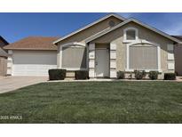 Charming single-story home with manicured lawn and white trimmed windows and door at 6335 E Brown Rd # 1065, Mesa, AZ 85205