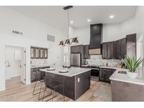 Modern kitchen featuring stainless steel appliances, a large island, and stylish pendant lighting at 862 W Rawhide Ave, Gilbert, AZ 85233