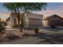 Single Gathering home with a two-car garage featuring desert landscaping in front at 10276 E Meandering Trail Ln, Gold Canyon, AZ 85118