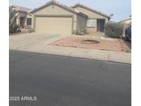 Charming single-story home featuring a two-car garage, desert landscaping, and a well-maintained front yard at 12034 W Aster Dr, El Mirage, AZ 85335