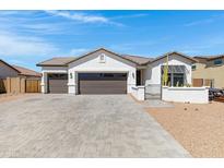 Charming single-story home showcasing a three-car garage and well-manicured desert landscaping at 17084 N Palo Pino St, Maricopa, AZ 85138