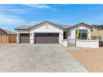 Inviting single-story home with a 3-car garage and stylish desert landscaping at 17084 N Palo Pino St, Maricopa, AZ 85138