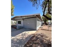 Charming single-story home features a low-pitched roof, light gray exterior, and lattice privacy screens at 2853 W Ohio St, Apache Junction, AZ 85120