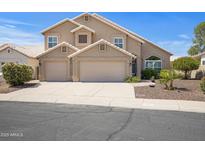 Charming two-story home featuring a three-car garage and desert landscaping at 4207 E Rockledge Rd, Phoenix, AZ 85044
