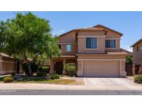 Charming two-story home with a well-maintained front yard and attached two-car garage at 44175 W Knauss Dr, Maricopa, AZ 85138
