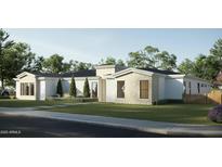 Modern home exterior with stone accents, manicured landscaping, and a well-maintained lawn at 5620 S Gemstone Dr, Chandler, AZ 85249