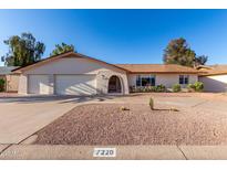 Charming single-story home featuring a neutral color scheme, desert landscaping, and a spacious two-car garage at 7220 E Edgewood Ave, Mesa, AZ 85208
