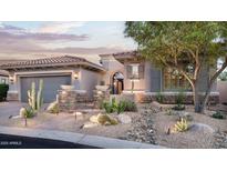 Charming home exterior with desert landscaping, stone accents, and a well-maintained facade and paved walkway at 9865 E Piedra Dr, Scottsdale, AZ 85255
