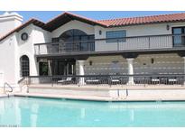 Enjoy the community pool with comfortable lounge chairs on the covered patio at 11011 N 92Nd St # 1096, Scottsdale, AZ 85260