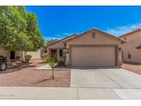 Charming single-Gathering home featuring a two-car garage, desert landscaping and mature shade tree at 12109 N 127Th Dr, El Mirage, AZ 85335
