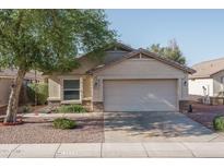 Charming single-story home featuring desert landscaping and a two-car garage, with easy street access at 13034 W Cheery Lynn Rd, Avondale, AZ 85392