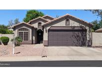 Charming single-story home with a two-car garage and desert landscaping at 14968 N 134Th Ln, Surprise, AZ 85379