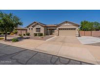Charming single-story home showcasing a spacious driveway and desert landscaping at 19042 E Arrowhead Trl, Queen Creek, AZ 85142