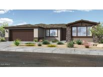 Charming single-story home featuring desert landscaping, a two-car garage, and a welcoming front entrance at 39604 N Kaden Ln, San Tan Valley, AZ 85140