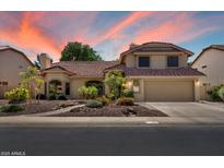 Charming two-story home featuring a well-manicured front yard and a spacious two-car garage at 401 N Cholla St, Chandler, AZ 85224