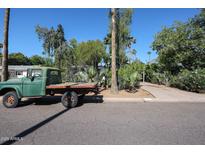 Street view showcasing a vintage pickup truck with mature landscaping and trees in a suburban setting at 4142 N 35Th St, Phoenix, AZ 85018