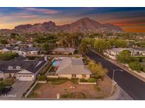 Inviting single-story home featuring an attached garage and stunning mountain views at sunset at 4596 E Calle Ventura --, Phoenix, AZ 85018
