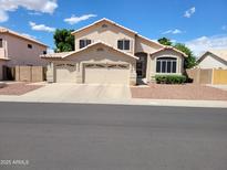 Charming two-story home featuring a three-car garage, manicured landscaping, and a neutral color palette at 4746 W Taro Dr, Glendale, AZ 85308