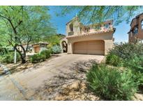 Tan two story home featuring a two car garage and desert landscaping at 9302 E Horseshoe Bend Dr, Scottsdale, AZ 85255