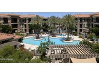 Expansive community pool features sun loungers, palm trees, and multiple swim areas at 11640 N Tatum Blvd # 3035, Phoenix, AZ 85028