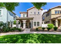 Charming two-story home features a covered porch, landscaped front yard, and well-maintained lawn, creating inviting curb appeal at 1324 S Banning St, Gilbert, AZ 85296