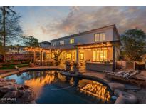 Beautiful backyard featuring a sparkling pool and shaded patio area, perfect for outdoor entertaining at 1421 W Saltsage Dr, Phoenix, AZ 85045