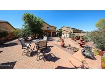 Extensive backyard space featuring various seating areas, desert landscaping, and a shed at 22022 W Moonlight Path, Buckeye, AZ 85326