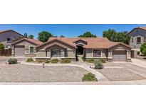Charming single-story home featuring a well-maintained landscape and a spacious driveway at 3060 E Hope St, Mesa, AZ 85213