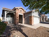 Charming single-story home with a brick facade and a well-maintained desert-style front yard at 35721 N Zachary Rd, Queen Creek, AZ 85144
