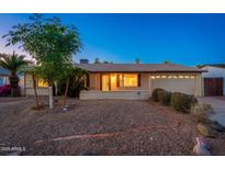 Charming single-story home with a landscaped front yard and an attached two-car garage at 3624 E Hearn Rd, Phoenix, AZ 85032