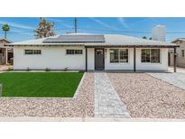 Charming home featuring a neatly manicured lawn and stylish walkway leading to the front door at 4531 N 12Th Dr, Phoenix, AZ 85013