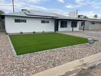 Newly renovated home featuring xeriscape and artificial grass at 4531 N 12Th Dr, Phoenix, AZ 85013
