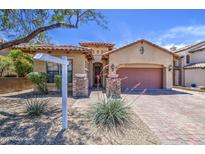 Inviting home featuring mature landscaping, a tile roof, and a large driveway at 6941 E Snowdon St, Mesa, AZ 85207